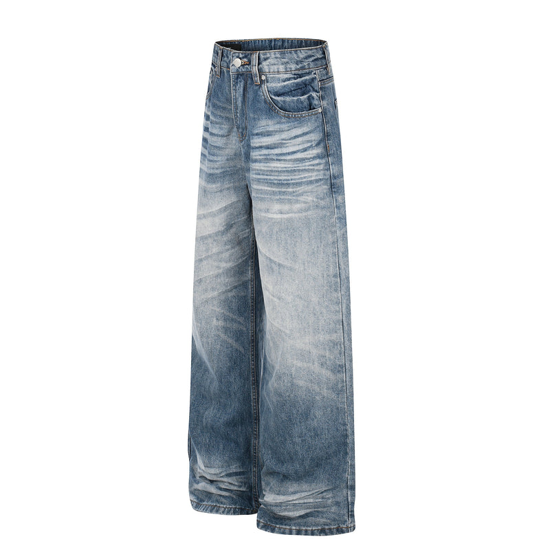 Angled front view of faded blue baggy jeans with wide legs and whiskered denim
