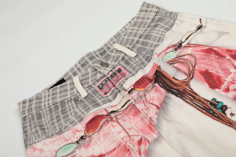 Close-up of waistband and upper front of gray plaid and pink printed denim pants