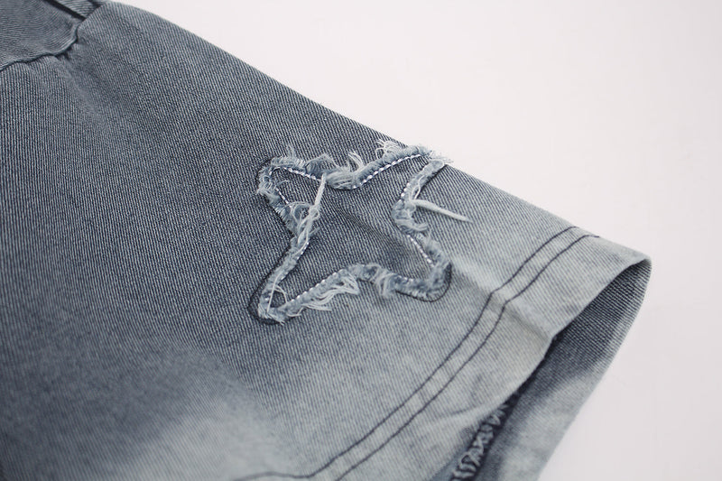 Vintage washed denim-gray T-shirt sleeve with distressed star patch and frayed edge detail