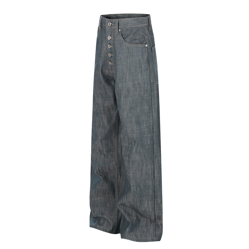 Angled front view of wide leg washed grey denim jeans showing button fly and front pockets