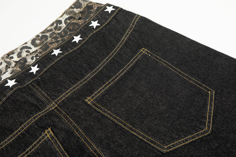 Close-up of the back pocket and leopard waistband on black denim jeans