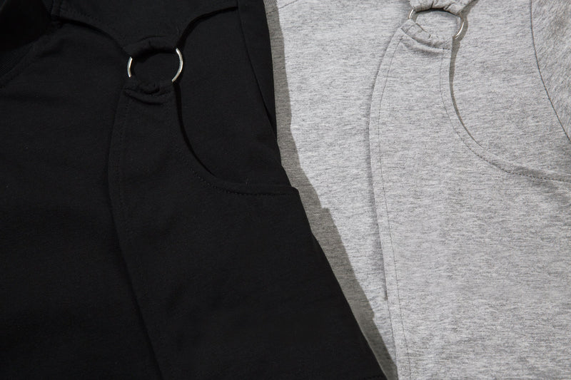 Close-up of black and light gray tee fronts showing metal ring chest details