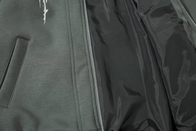 Close-up of inside lining and front pocket area on dark green hoodie