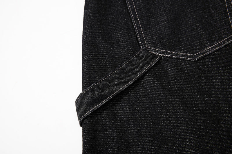 Side seam and hem detail on black wide-leg black denim jeans