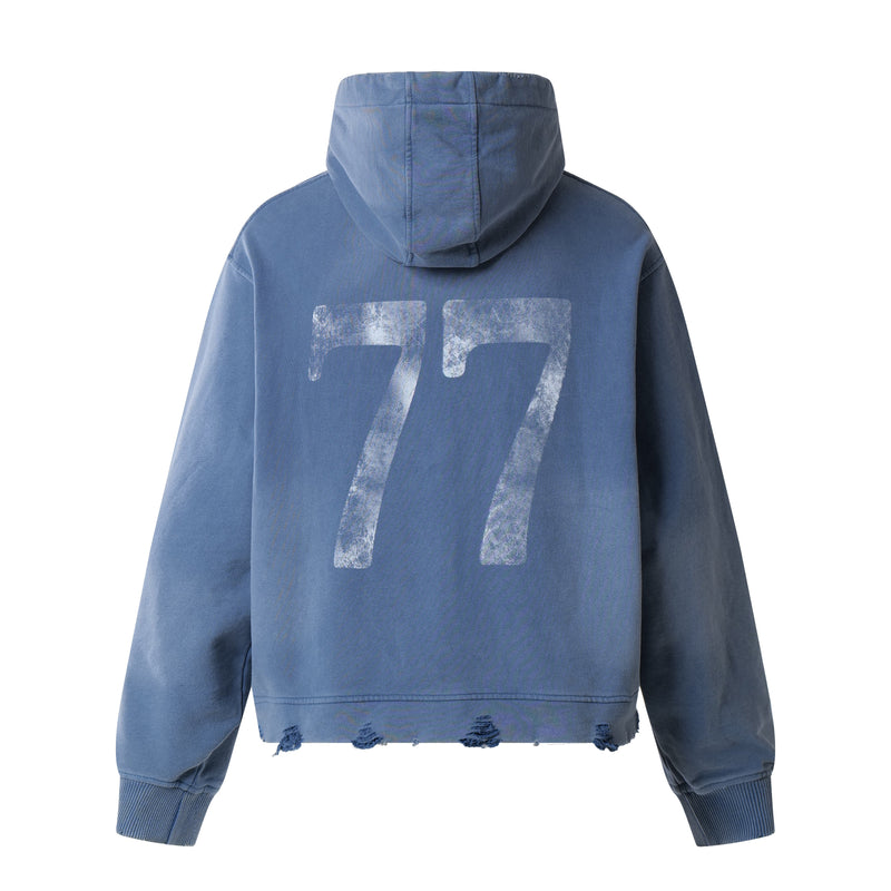 Blue distressed graphic hoodie showing the back with large faded number 77 print