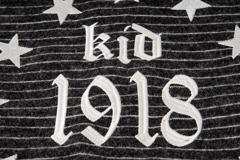 Close-up of black striped knit back graphic with Battlekid and 1918 text