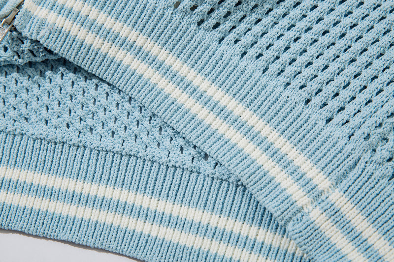 Close-up of light blue sleeve and ribbed cuff with white stripe detail