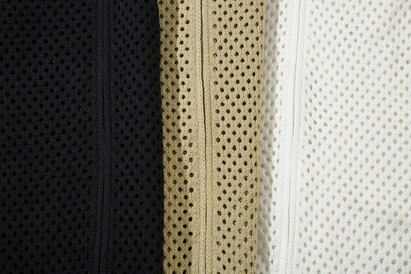 Close-up of black, beige, and white striped mesh knit fabric