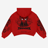 The limited edition Zenitsu Agatsuma-Inspired "Thunder God" hoodie by Demon Slayer features a bold design with lightning bolts and the word "THUNDER" against anime streetwear vibes. Sleeves have dragon and flame motifs, various text styles, and a hood up against a plain background.