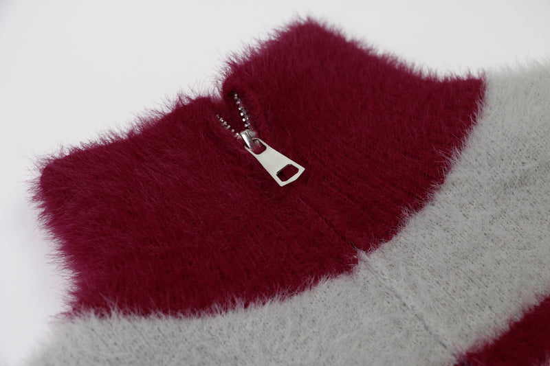 Close-up of burgundy fuzzy collar with silver half-zip zipper pull
