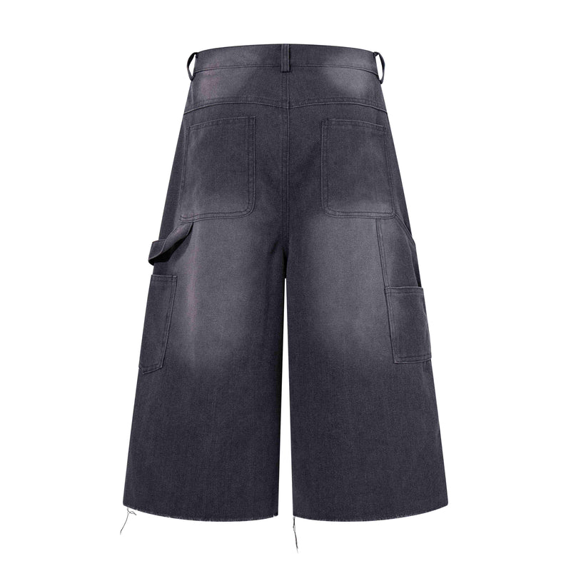 Back view of dark denim wide-leg shorts with patch pockets and cargo-style side pocket