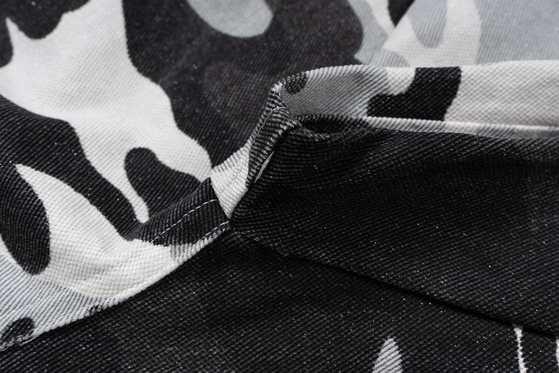 Close-up of camo fabric with black and white print and seam texture