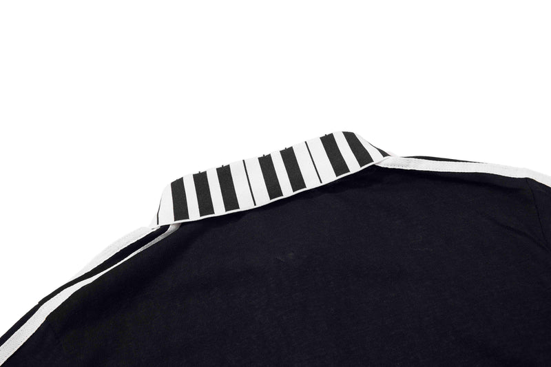 Black polo shirt with white striped collar and trim, shown in a close-up view against a plain white background