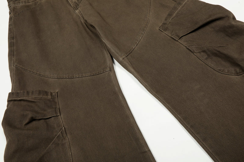 Close-up of brown cargo pants thigh with flap cargo pocket and curved seam