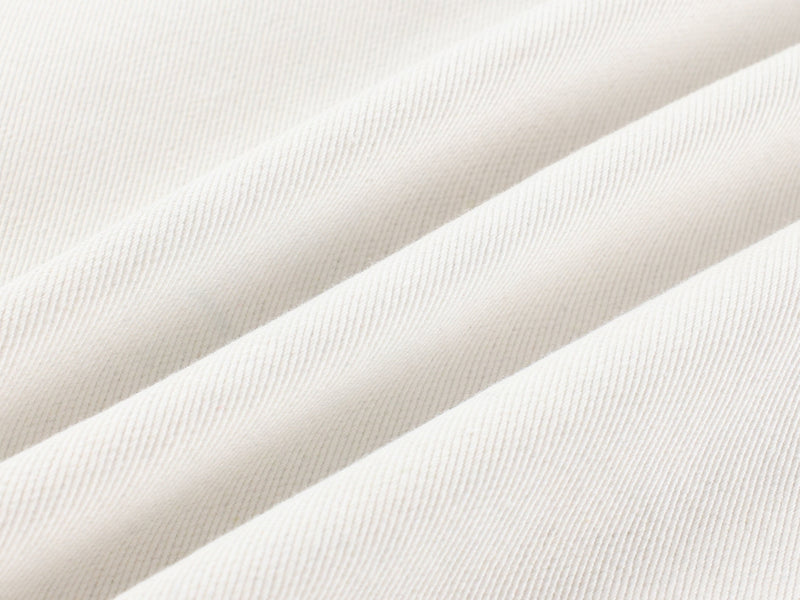 Close-up of white denim fabric texture with subtle ribbed weave
