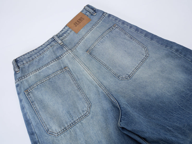 Close-up of back waistband and pocket on blue denim jeans with leather logo patch