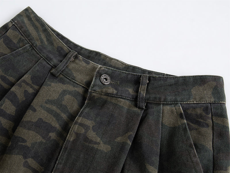 Close-up of black camo cargo pants waistband with button closure and pleats