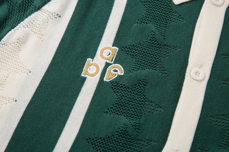 Close-up of green striped knit polo front with small embroidered chest detail and buttons