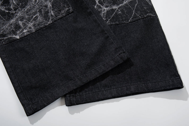 Close-up of black denim leg hem with straight stitched finish