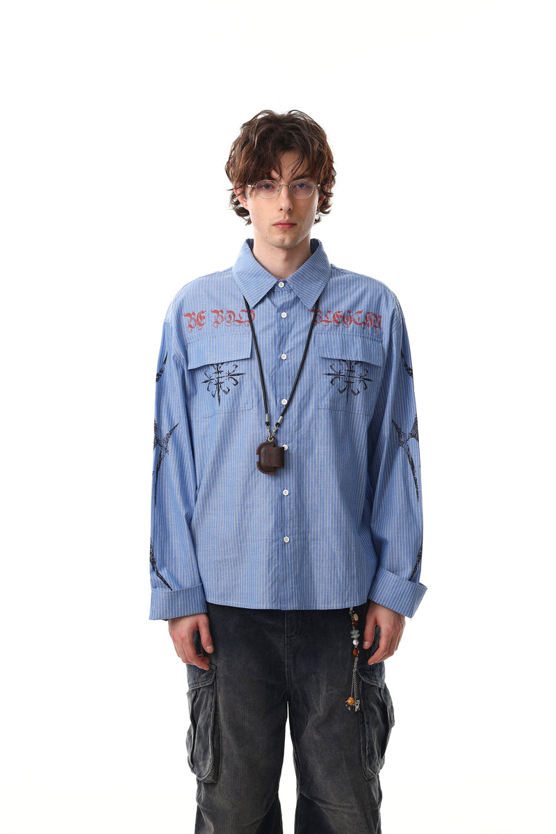 Blue striped button-up shirt worn with graphic print and long sleeves, front view on model
