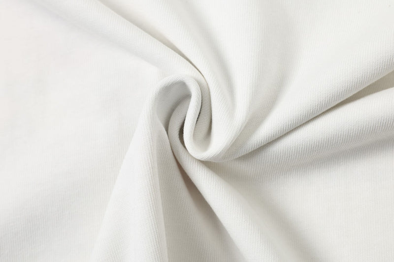 Close-up of white washed cotton tee fabric with soft textured knit and draped folds