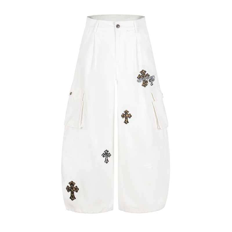 White wide-leg cargo pants with leopard cross patches and side flap pockets