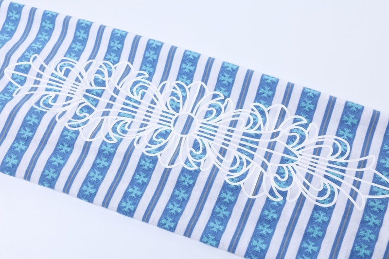 White floral sleeve graphic on blue striped long sleeve polo close-up
