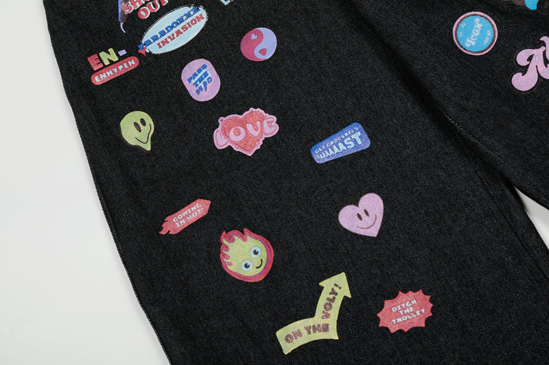 Close-up of assorted colorful patch graphics on black denim pants