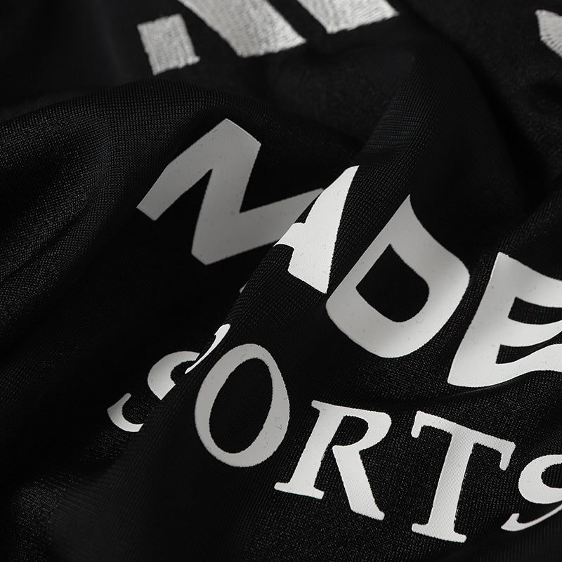Close-up of a black sports club football jersey with bold white MADEGPSR lettering and No. 9 print