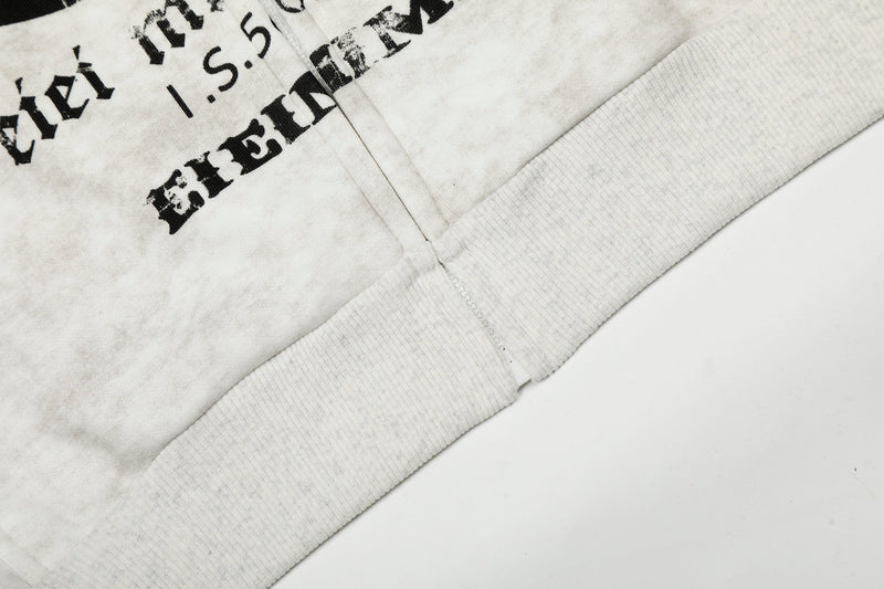 Close-up of lower hem and ribbed waistband on white zip-up hoodie