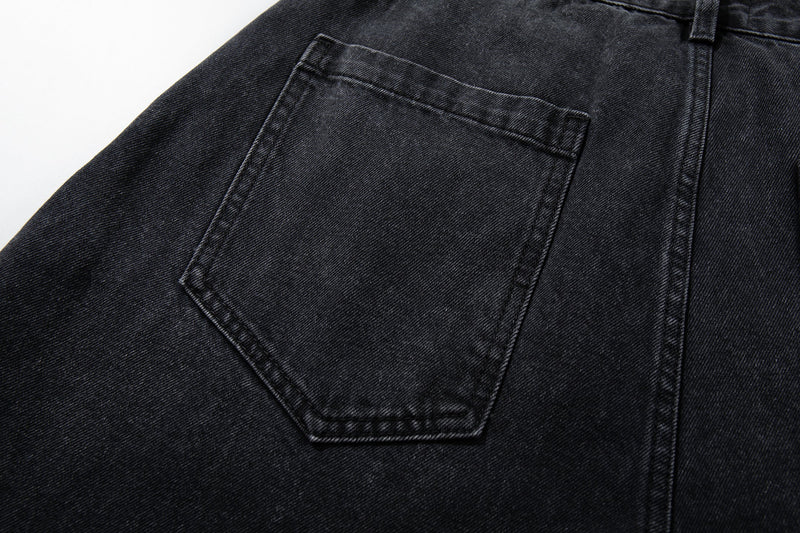 Close-up of back pocket on washed charcoal paneled denim pants