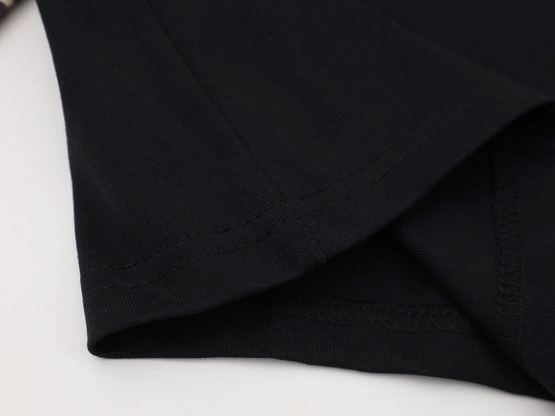Close-up of black sleeve hem with neat stitching and curved edge