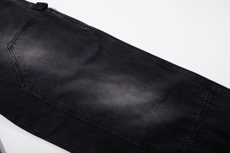 Close-up of gradient washed black denim on wide-leg carpenter jeans