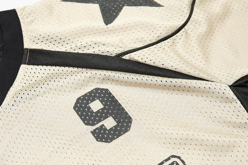 Close-up of a cream mesh sports jersey with black trim and a bold number 9 graphic on the front