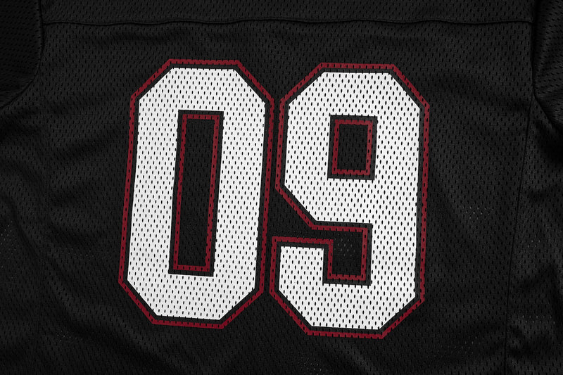 Black mesh jersey back close-up showing white 09 numbers with red outline