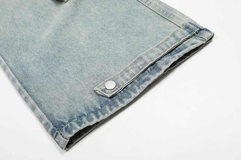 Light wash denim hem with metal snap tab detail