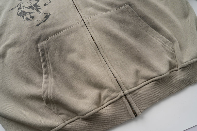 Front pocket and zipper hem detail on taupe zip-up hoodie