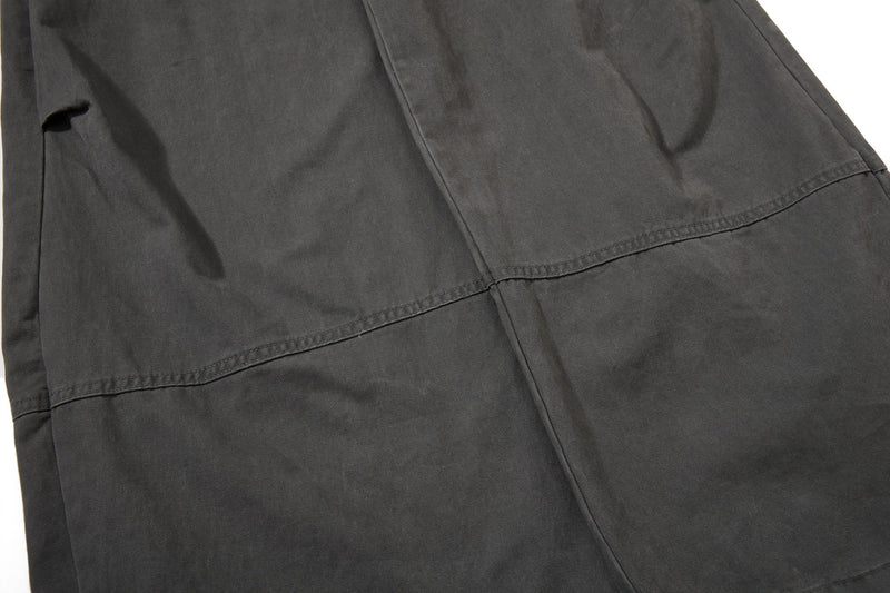 Close-up of black pant leg with horizontal seam detail