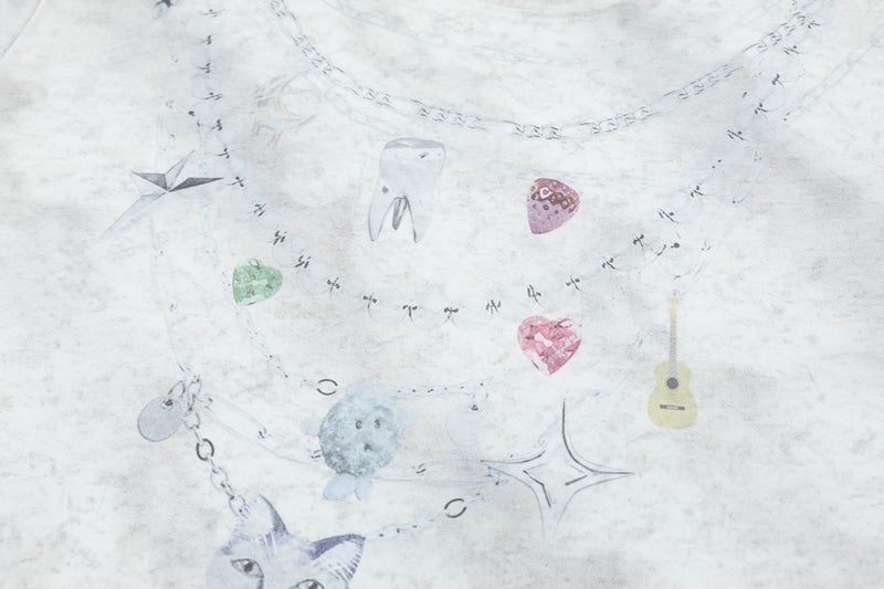 White tie-dye graphic tee with layered charm necklaces, colorful gem pendants, and a small guitar print