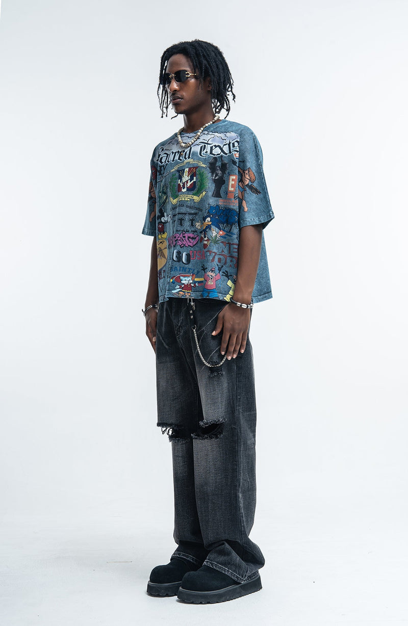 Vintage wash oversized graphic tee with all-over print, worn with distressed black jeans and chunky boots