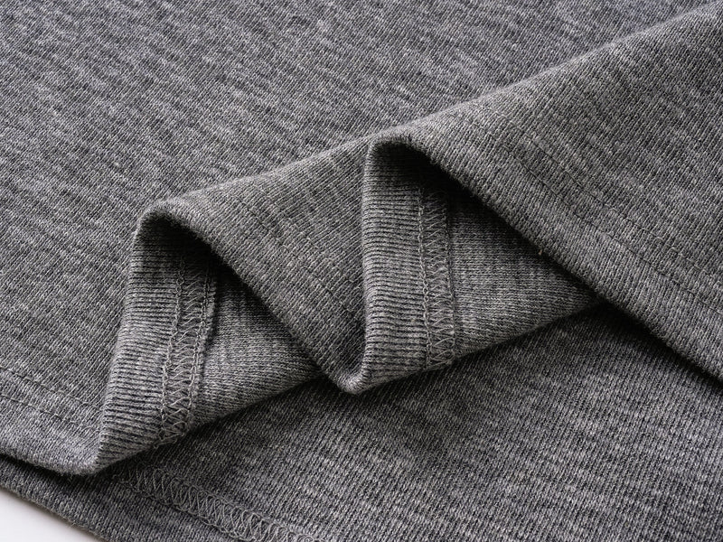 Close-up of gray tee sleeve cuff and seam with folded fabric detail