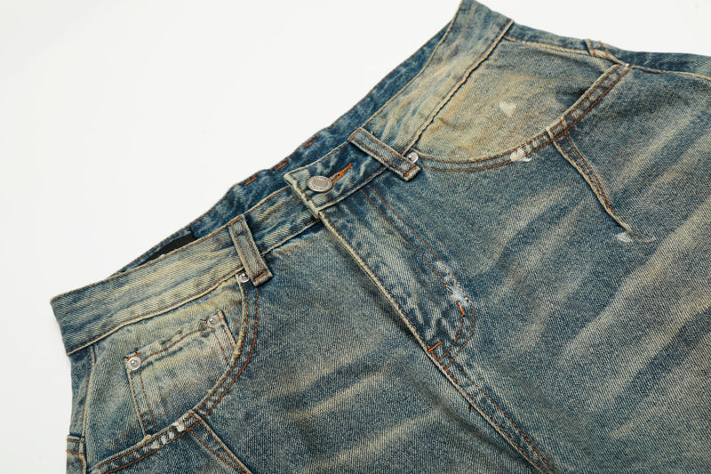 Close-up of waistband and front pocket on faded blue denim jeans with contrast stitching