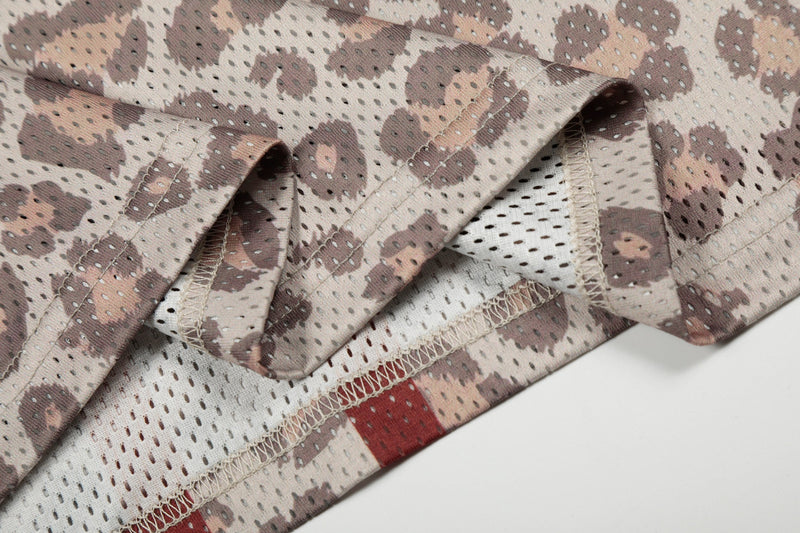 Close-up of leopard print mesh jersey fabric with stitched seams and perforated sporty texture in beige and brown tones
