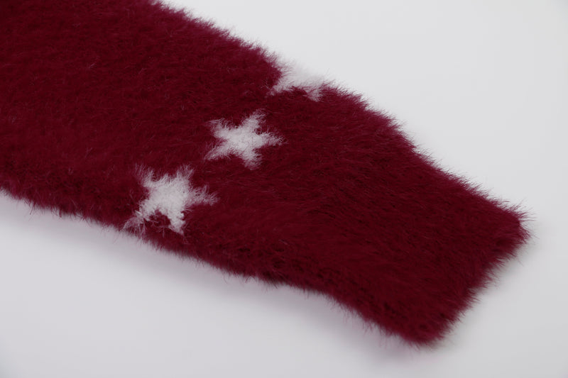Close-up of burgundy fuzzy sleeve with white star detail