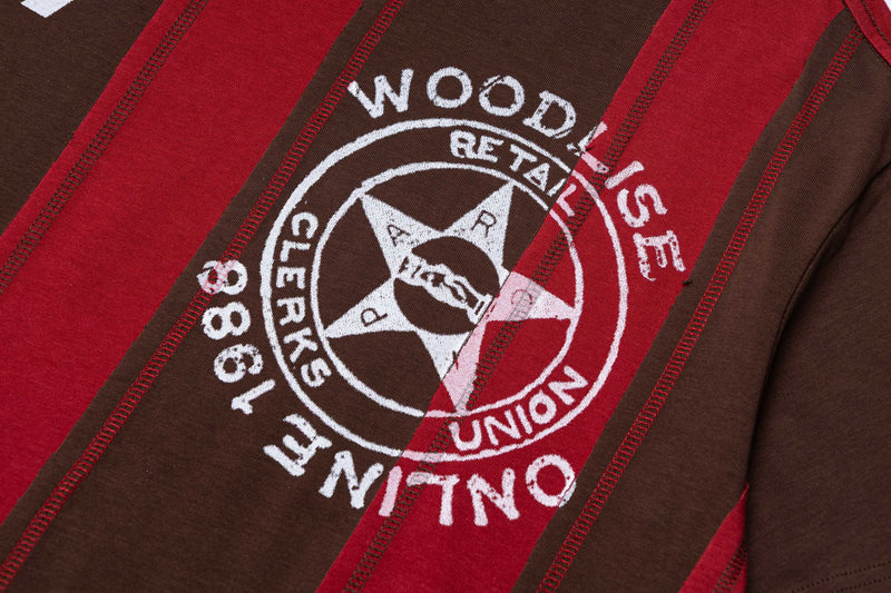 Close-up of a retro oversized T-shirt with red and brown stripes and a white Woodline Club Union graphic print