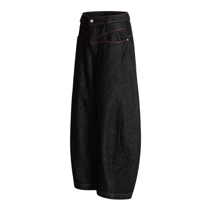 Side view of black barrel jeans with red contrast stitching and wide leg shape