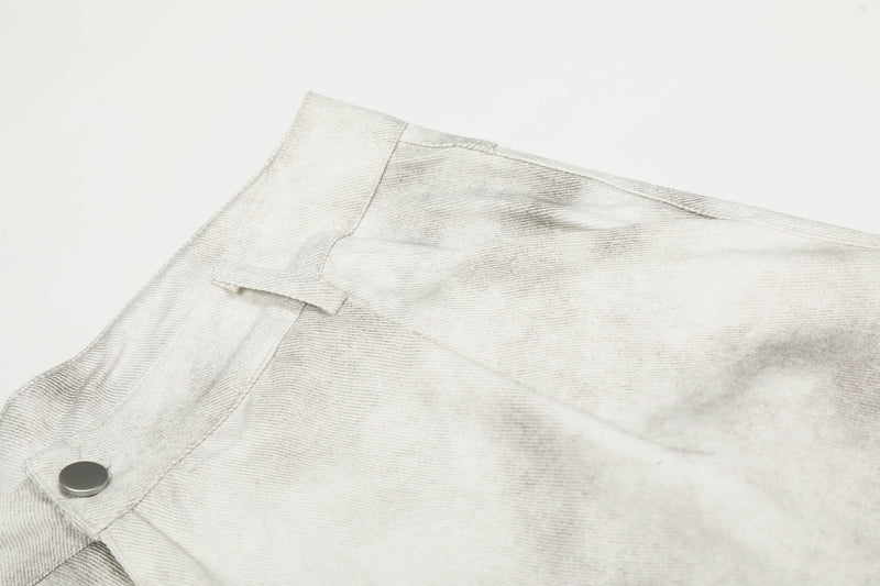 Close-up of the upper side waistband and pocket seam on white washed cargo pants