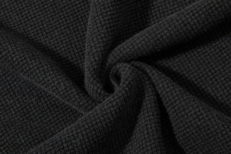 Close-up of black waffle knit fabric with a soft vintage texture for a graphic T-shirt