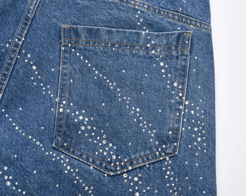Close-up of blue denim shorts back pocket with rhinestone burst pattern