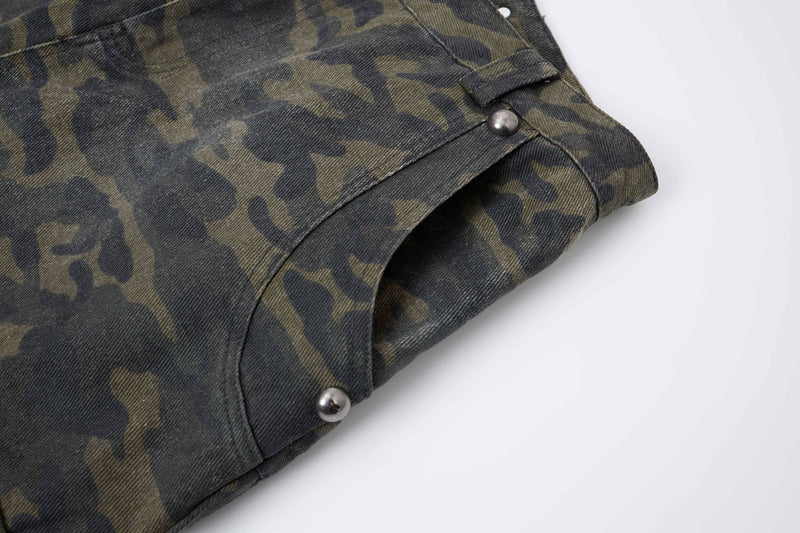 Close-up of camo cargo pants cuff with folded hem and silver stud detail
